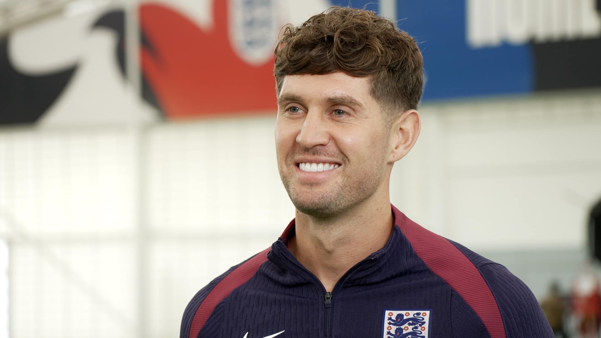 England player in training jersey at indoor facility